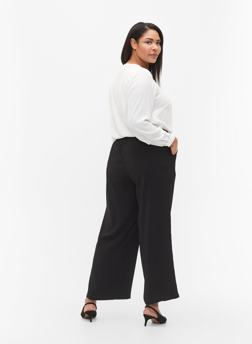 Pantalon &eacute;vas&eacute; &agrave; poches, Noir, Model image number 1