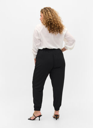 Pantalon avec poches et ourlet élastique, Black, Model image number 1